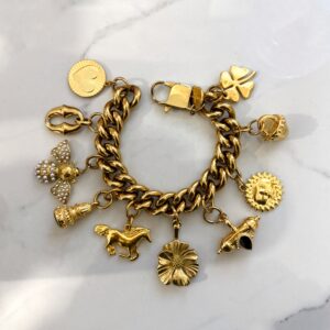 gold charm bracelet , trendy jewllery brand , vintage style bracelet , statement jewllery collection